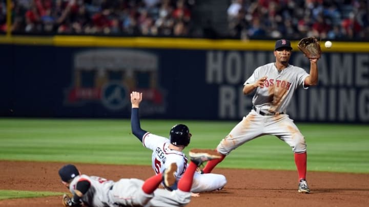 Apr 25, 2016; Atlanta, GA, USA; Boston Red Sox second baseman Dustin Pedroia (on the ground) flips the ball to shortstop Xander Bogaerts (2) to force out Atlanta Braves first baseman Freddie Freeman (5) during the seventh inning at Turner Field. Mandatory Credit: Dale Zanine-USA TODAY Sports