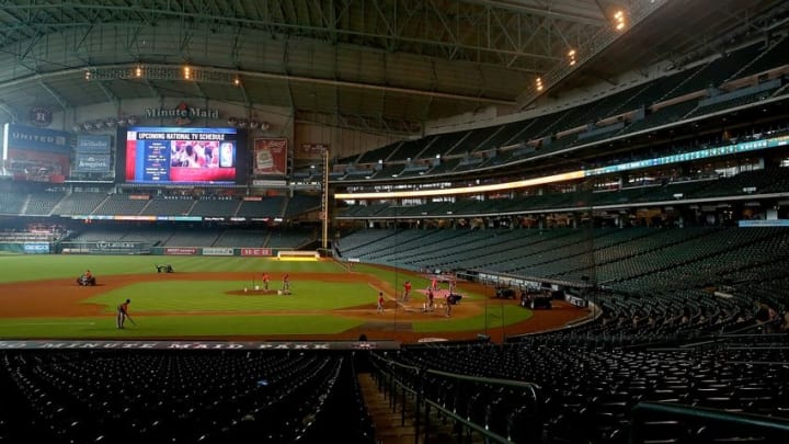 May 17, 2015; Houston, TX, USA; Game seven of the second round of the NBA Playoffs between the Houston Rockets and the Los Angeles Clippers is displayed on the jumbotron as the grounds crew works on the field following the Houston Astros 4-2 victory over the Toronto Blue Jays at Minute Maid Park. Mandatory Credit: Thomas B. Shea-USA TODAY Sports