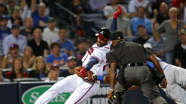 Apr 22, 2016; Atlanta, GA, USA; Atlanta Braves right fielder Nick Markakis (22) is tagged out by New York Mets catcher Travis d Apr 22, 2016; Atlanta, GA, USA; Atlanta Braves right fielder Nick Markakis (22) is tagged out by New York Mets catcher Travis d
