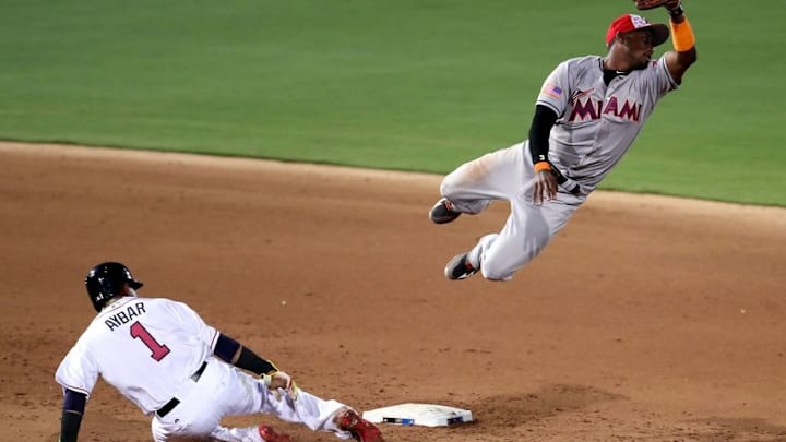 Jul 3, 2016; Ft. Bragg, NC, USA; Miami Marlins shortstop Adeiny Hechavarria (3) misses a throw as Atlanta Braves shortstop Erick Aybar (1) slides into second base during the fifth inning at Fort Bragg. Mandatory Credit: Peter Casey-USA TODAY Sports