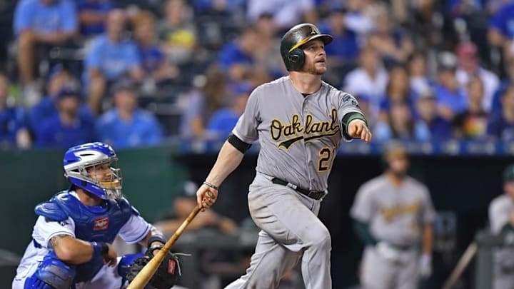 Sep 15, 2016; Kansas City, MO, USA; Oakland Athletics catcher Stephen Vogt (21) hits a two run home run against the Kansas City Royals during the sixth inning at Kauffman Stadium. Mandatory Credit: Peter G. Aiken-USA TODAY Sports