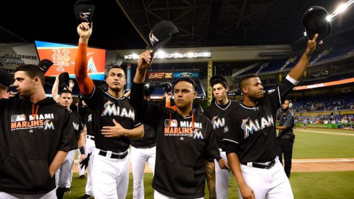 Sep 28, 2016; Miami, FL, USA; Miami Marlins right fielder Giancarlo Stanton (left) relief pitcher A.J. Ramos (center) and first baseman Xavier Scruggs (right) waves to the fans after their last home game of the year at Marlins Park. The Mets won 5-2. Mandatory Credit: Steve Mitchell-USA TODAY Sports