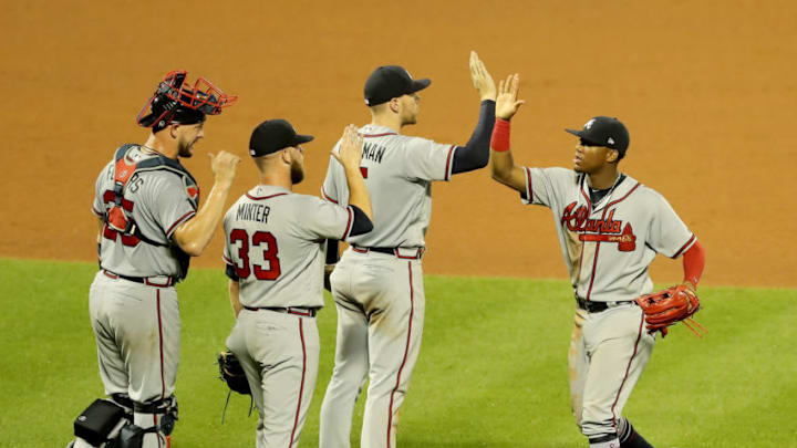 NEW YORK, NY - AUGUST 02: Ronald Acuna Jr. #13 of the Atlanta Braves celebrates the 4-2 win over the New York Mets with teammates Freddie Freeman #5,A.J. Minter #33 and Tyler Flowers #25 after the game on August 2, 2018 at Citi Field in the Flushing neighborhood of the Queens borough of New York City. (Photo by Elsa/Getty Images)