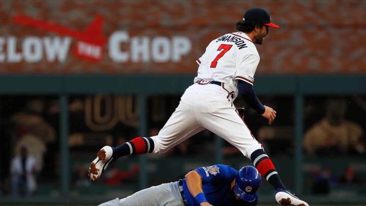 ATLANTA, GEORGIA – APRIL 01: Dansby Swanson #7 of the Atlanta Braves turns a double play over David Bote #13 of the Chicago Cubs in the second inning on April 01, 2019 in Atlanta, Georgia. (Photo by Kevin C. Cox/Getty Images)
