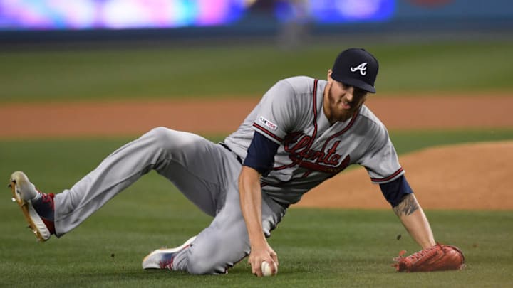 LOS ANGELES, CA - MAY 06: Starting pitcher Kevin Gausman #45 of the Atlanta Braves reaches for the ball and throws it erroneously to first base for a base hit by Cody Bellinger #35 of the Los Angeles Dodgers during the first inning at Dodger Stadium on May 6, 2019 in Los Angeles, California. (Photo by Kevork Djansezian/Getty Images)