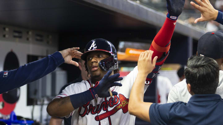 ATLANTA, GA – AUGUST 13: Ronald Acuna Jr. #13 of the Atlanta Braves high fives teammates in the dugout after hitting a home run in fourth inning during the game against the New York Mets at SunTrust Park on August 13, 2019 in Atlanta, Georgia. (Photo by Carmen Mandato/Getty Images)