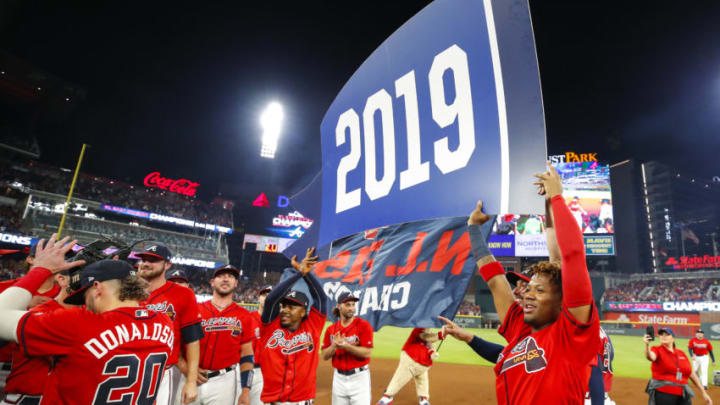 ATLANTA, GA - SEP 20: Ozzie Albies #1 of the Atlanta Braves and Ronald Acuna Jr. #13 hold up a 2019 banner at the conclusion of an MLB game against the San Francisco Giants in which they clinched the NL East at SunTrust Park on September 20, 2019 in Atlanta, Georgia. (Photo by Todd Kirkland/Getty Images)