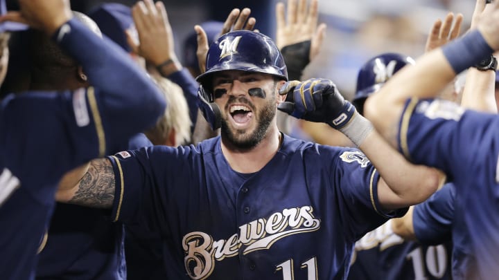 MIAMI, FLORIDA – SEPTEMBER 11: Mike  Moustakas #11 of the Milwaukee Brewers celebrates with teammates after hitting a go-ahead two-run home run in the ninth inning against the Miami Marlins at Marlins Park on September 11, 2019 in Miami, Florida. (Photo by Michael Reaves/Getty Images)