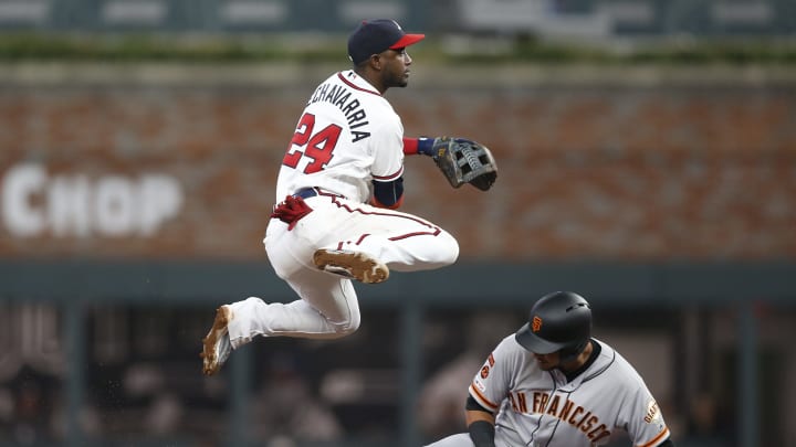 ATLANTA, GEORGIA – SEPTEMBER 21: Second baseman Adeiny  Hechavarria #24 of the Atlanta Braves turns a double play over second baseman Cristhian Adames #14 of the San Francisco Giants in the fifth inning during the game at SunTrust Park on September 21, 2019 in Atlanta, Georgia. (Photo by Mike Zarrilli/Getty Images)