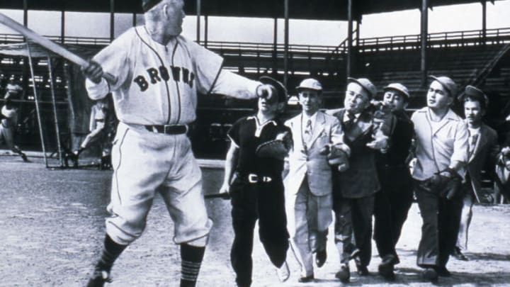 ST. LOUIS - CIRCA 1952: Hall of Famer Rogers Hornsby, manager of the St. Louis Browns pretends to fend off a group of Brownies, or little people, at a photo op at Sportsmans Park in St. Louis, Missouri in 1952. (Photo Reproduction by Transcendental Graphics/Getty Images)