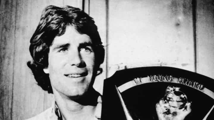 American baseball player Jim Palmer holds up his Cy Young award, one of three he won over the course of his career, 1975. (Photo by Hulton archive/Getty Images)