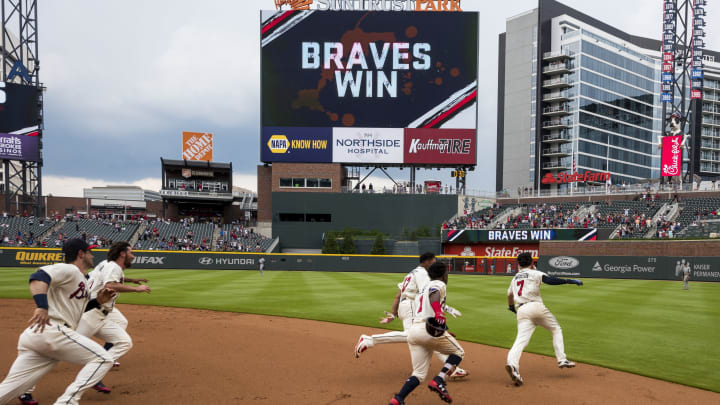 The Atlanta Braves start to celebrate another dramatic win. (Photo by Logan Riely/Beam Imagination/Atlanta Braves/Getty Images)