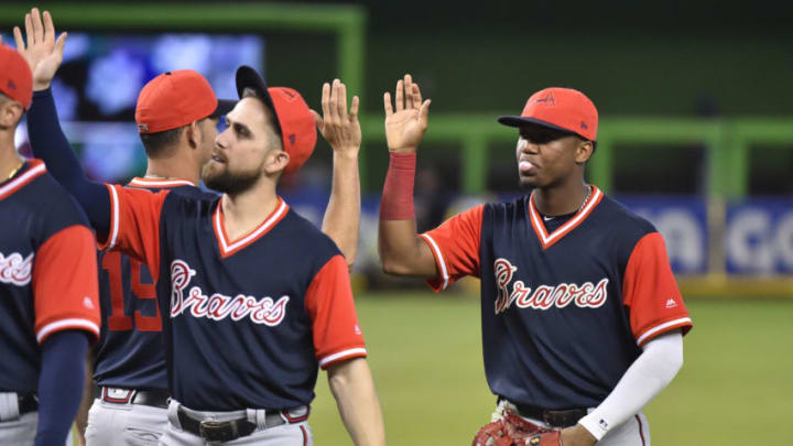 MIAMI, FL - AUGUST 26: Ronald Acuna Jr. #13 of the Atlanta Braves high fives teammates after defeating the Miami Marlins at Marlins Park on August 26, 2018 in Miami, Florida. All players across MLB will wear nicknames on their backs as well as colorful, non-traditional uniforms featuring alternate designs inspired by youth-league uniforms during Players Weekend. (Photo by Eric Espada/Getty Images)