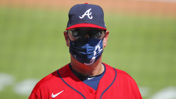 Manager Brian Snitker of the Atlanta Braves is hiding his feelings. (Photo by Todd Kirkland/Getty Images)