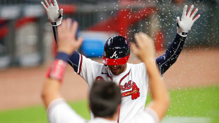 Nick Markakis of the Atlanta Braves approaches home plate after hitting a walk-off home run. (Photo by Todd Kirkland/Getty Images)