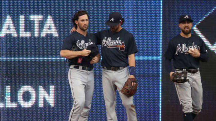 TORONTO, ON – JUNE 19: Charlie Culberson #16 of the Atlanta Braves is helped up by Dansby Swanson #7 after making a catch and crashing into the wall in the first inning during MLB game action against the Toronto Blue Jays at Rogers Centre on June 19, 2018 in Toronto, Canada. (Photo by Tom Szczerbowski/Getty Images)