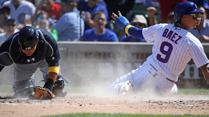 CHICAGO, IL - SEPTEMBER 01: Javier Baez #9 of the Chicago Cubs scores a run in the 3rd inning past Kurt Suzuki #24 of the Atlanta Braves at Wrigley Field on September 1, 2017 in Chicago, Illinois. (Photo by Jonathan Daniel/Getty Images)