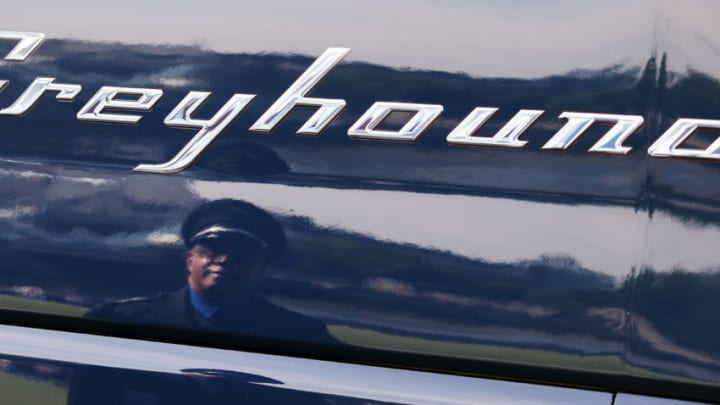 LONDON, ENGLAND - AUGUST 19: Leon Batchelor, a Greyhound coach driver from Philadelphia is reflected in the first Greyhound coach to operate in the UK on August 19, 2009 in London, England. The iconic North American inter-city bus company is beginning services in the UK operating from London to Portsmouth and Southampton. (Photo by Oli Scarff/Getty Images)