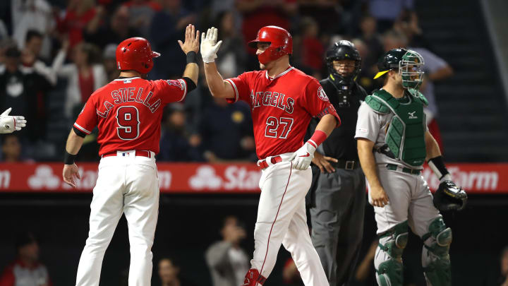 ANAHEIM, CALIFORNIA – JUNE 06: Tommy La Stella #9 congratulates Mike Trout #27 of the Los Angeles Angels of Anaheim after his two-run homerun as Josh Phegley #19 of the Oakland Athletics and umpire Kerwin Danley look on during the fifth inning of a game at Angel Stadium of Anaheim on June 06, 2019 in Anaheim, California. (Photo by Sean M. Haffey/Getty Images)