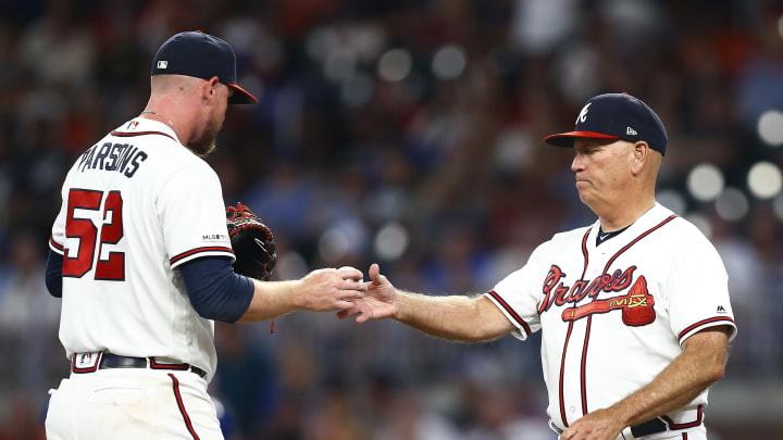 ATLANTA, GEORGIA – JULY 23: Manager Brian Snitker #43 of the Atlanta Braves takes the ball from relief pitcher Wes Parsons #52 in the eighth inning during the game against the Kansas City Royals at SunTrust Park on July 23, 2019 in Atlanta, Georgia. (Photo by Mike Zarrilli/Getty Images)