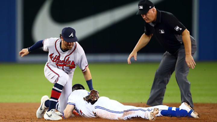 TORONTO, ON - AUGUST 27: Dansby Swanson #7 of the Atlanta Braves tags Cavan Biggio #8 of the Toronto Blue Jays out a second base in the third inning during an MLB game at Rogers Centre on August 27, 2019 in Toronto, Canada. (Photo by Vaughn Ridley/Getty Images)