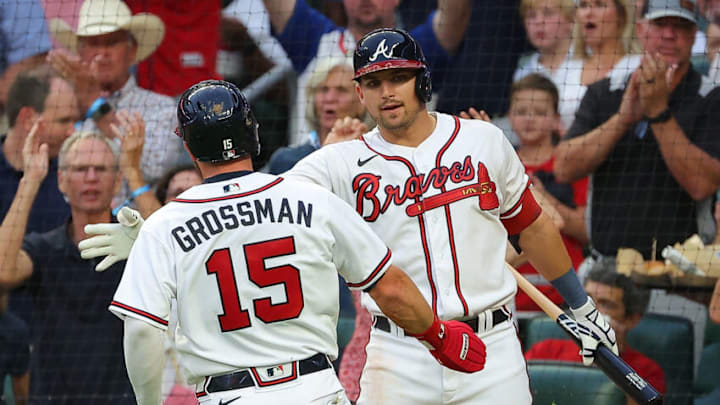 ATLANTA, GEORGIA - AUGUST 18: Robbie Grossman #15 of the Atlanta Braves celebrates with Austin Riley #27 after scoring on a RBI double by Dansby Swanson #7 in the third inning at Truist Park on August 18, 2022 in Atlanta, Georgia. (Photo by Kevin C. Cox/Getty Images)