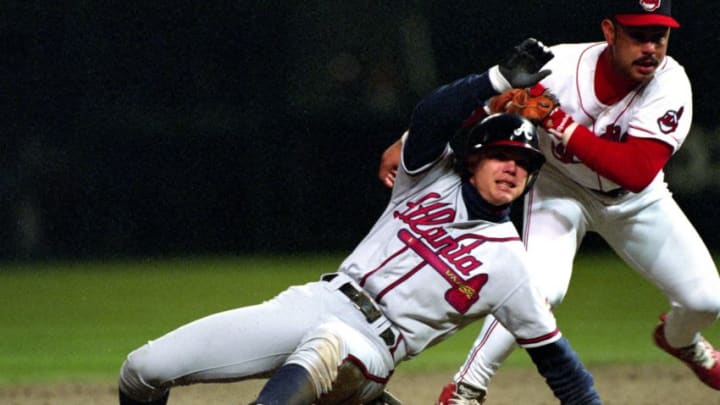 CLEVELAND, OH - OCTOBER 1995: Chipper Jones #10 of the Atlanta Braves slides into second base as Carlos Baerga #9 of the Cleveland Indians tries to make the tag during Game 3 of the World Series on October 23, 1995 in Cleveland, Ohio. (Photo by Ronald C. Modra/Getty Images)