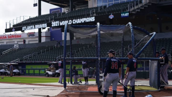 Atlanta Braves outfielder Adam Duvall (14) stands near the batting cage with bench coach Walt Weiss (4) during spring training work outs at Cool Today Park. Mandatory Credit: Jasen Vinlove-USA TODAY Sports