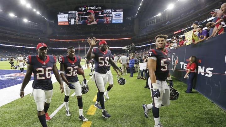 Aug 20, 2016; Houston, TX, USA; Houston Texans running back Lamar Miller (26) defensive back Robert Nelson (32) outside linebacker Whitney Mercilus (59) linebacker Brennan Scarlett (57) wave as they walk off the field after defeating the New Orleans Saints in the second half at NRG Stadium. Texans won 16-9. Mandatory Credit: Thomas B. Shea-USA TODAY Sports