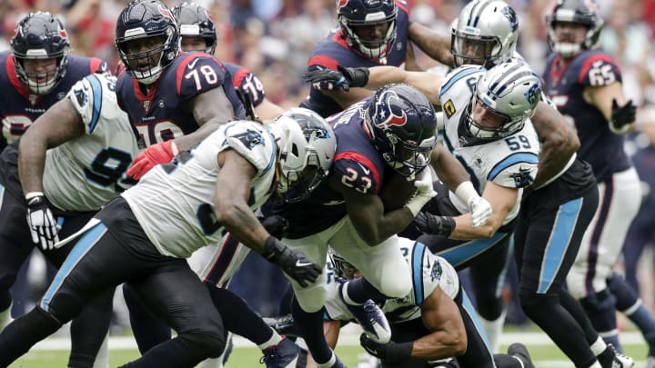 HOUSTON, TX – SEPTEMBER 29: Carlos Hyde #23 of the Houston Texans is tackled by Shaq Thompson #54 and Luke Kuechly #59 of the Carolina Panthers in the first half at NRG Stadium on September 29, 2019 in Houston, Texas. (Photo by Tim Warner/Getty Images)