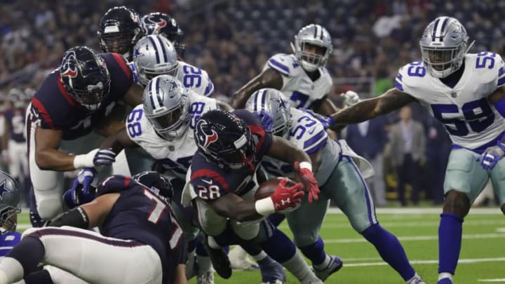 HOUSTON, TX - AUGUST 30: Alfred Blue #28 of the Houston Texans dives across the goal line for a touchdown defended by Justin March-Lillard #53 of the Dallas Cowboys and Daniel Ross #68 in the first half of the preseason game at NRG Stadium on August 30, 2018 in Houston, Texas. (Photo by Tim Warner/Getty Images)