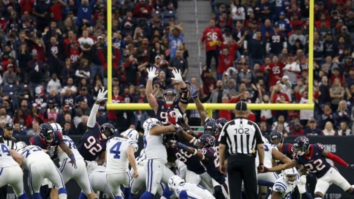 HOUSTON, TX - DECEMBER 09: Adam Vinatieri #4 of the Indianapolis Colts kicks a field goal to end the first half defended by J.J. Watt #99 of the Houston Texans at NRG Stadium on December 9, 2018 in Houston, Texas. (Photo by Tim Warner/Getty Images)