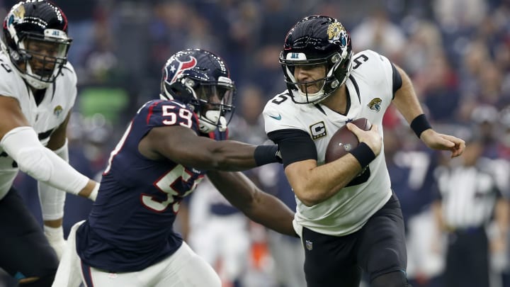 HOUSTON, TX – DECEMBER 30: Blake Bortles #5 of the Jacksonville Jaguars scrambles out of the pocket under pressure by Whitney Mercilus #59 of the Houston Texans in the first quarter at NRG Stadium on December 30, 2018 in Houston, Texas. (Photo by Tim Warner/Getty Images)