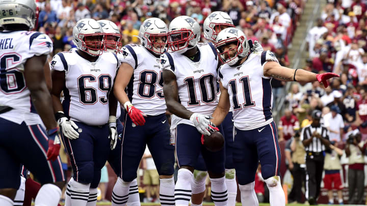 LANDOVER, MARYLAND – OCTOBER 06: Julian Edelman #11 of the New England Patriots is congratulated by his teammates after scoring a first quarter touchdown against the Washington Redskins in the game at FedExField on October 06, 2019 in Landover, Maryland. (Photo by Patrick McDermott/Getty Images)