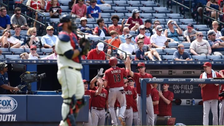 Aug 16, 2015; Atlanta, GA, USA; Arizona Diamondbacks shortstop Nick Ahmed (13) is greeted by his dugout after scoring the tying run against the Atlanta Braves during the eighth inning at Turner Field. Mandatory Credit: Dale Zanine-USA TODAY Sports