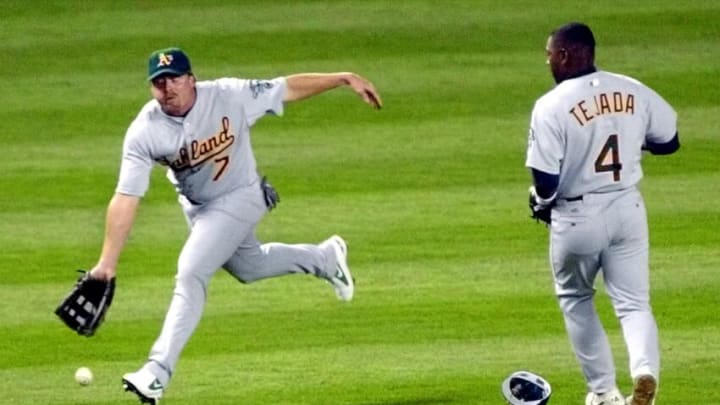 Oakland Athletics left fielder Jeremy Giambi (L) and shortstop MiguelTejada can't come up with a bloop double off the bat of New York Yankee second baseman Alfonso Soriano in the fifth inning 01 May 2002 at Yankee Stadium in the Bronx, NY. AFP PHOTO/Matt CAMPBELL (Photo by MATT CAMPBELL / AFP) (Photo credit should read MATT CAMPBELL/AFP via Getty Images)