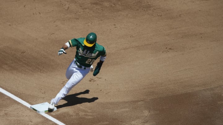 OAKLAND, CALIFORNIA - AUGUST 06: Ramon Laureano #22 of the Oakland Athletics rounds third base on the way to score on a single hit by Mark Canha #20 in the bottom of the fourth inning against the Texas Rangers at Oakland-Alameda County Coliseum on August 06, 2020 in Oakland, California. (Photo by Lachlan Cunningham/Getty Images)