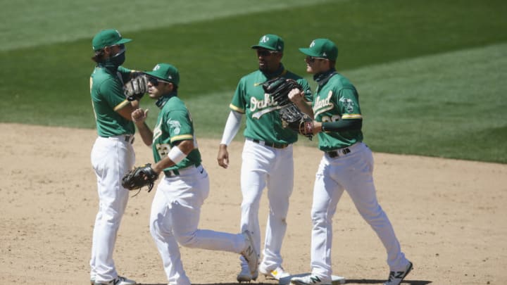 OAKLAND, CALIFORNIA - AUGUST 06: Oakland Athletics players Chad Pinder #18, Ramon Laureano #22, Marcus Semien #10 and Mark Canha #20 celebrate after a win against the Texas Rangers at Oakland-Alameda County Coliseum on August 06, 2020 in Oakland, California. (Photo by Lachlan Cunningham/Getty Images)