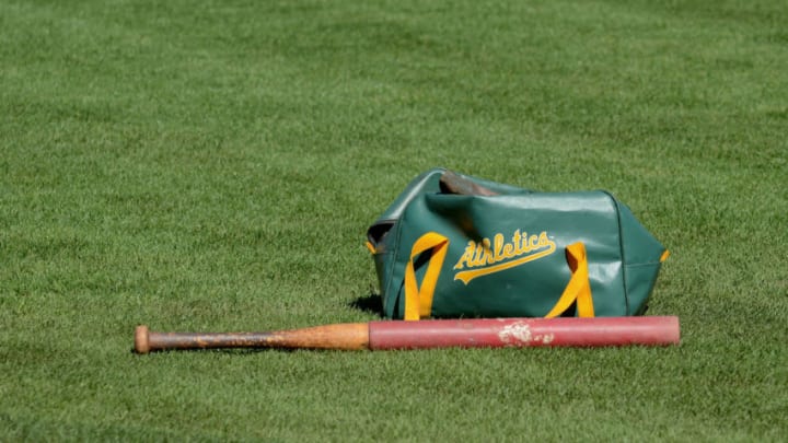 OAKLAND, CA - OCTOBER 08: A detailed view of a Oakland Athletics equipment bag and bat laying on the field during the American League Division Series Workout Day at Oakland-Alameda County Coliseum on October 8, 2012 in Oakland, California. The Detroit Tigers lead the Oakland Athletics 2 games to 0 in the ALDS. (Photo by Mark Cunningham/MLB Photos via Getty Images)