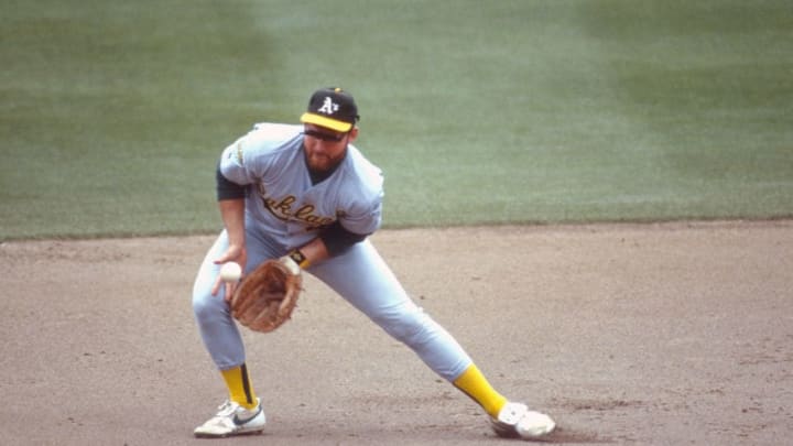 UNSPECIFIED - CIRCA 1990: Carney Lansford #4 of the Oakland Athletics goes down to field a ground ball during an Major League Baseball game circa 1990. Lansford played for the Athletics from 1983-92. (Photo by Focus on Sport/Getty Images)