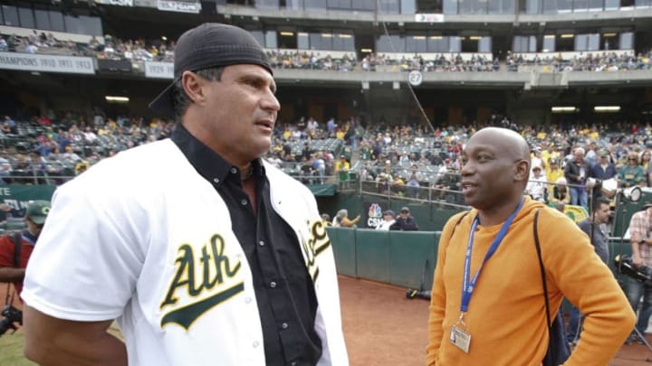 OAKLAND, CA - SEPTEMBER 3: Jose Canseco talks with Howard Bryant of ESPN on the field prior to the game between against the Oakland Athletics at the Oakland Coliseum on September 3, 2016 in Oakland, California. The Red Sox defeated the Athletics 11-2. (Photo by Michael Zagaris/Oakland Athletics/Getty Images)