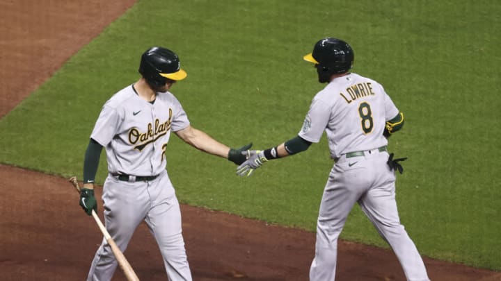 Apr 9, 2021; Houston, Texas, USA; Oakland Athletics second baseman Jed Lowrie (8) celebrates with first baseman Matt Olson (28) after hitting a home run during the fourth inning against the Houston Astros at Minute Maid Park. Mandatory Credit: Troy Taormina-USA TODAY Sports