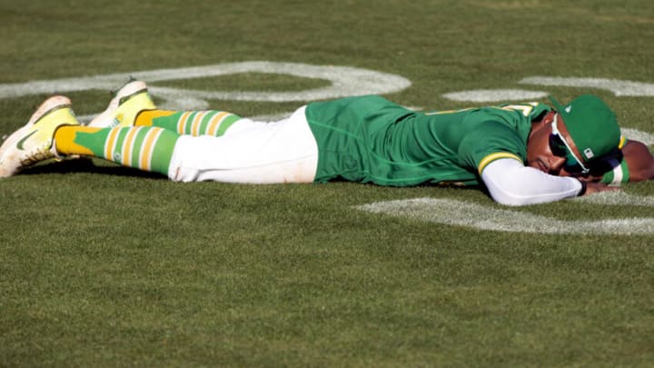 Oct 5, 2022; Oakland, California, USA; Oakland Athletics left fielder Tony Kemp (5) lays on the field following his team’s final game of the season, a 3-2 victory over the Los Angeles Angels at RingCentral Coliseum. Mandatory Credit: D. Ross Cameron-USA TODAY Sports