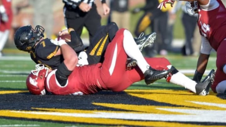 Nov 28, 2014; Columbia, MO, USA; Missouri Tigers quarterback Maty Mauk (7) is sacked by Arkansas Razorbacks defensive lineman Mitchell Loewen (89) during the first half at Faurot Field. Mandatory Credit: Denny Medley-USA TODAY Sports