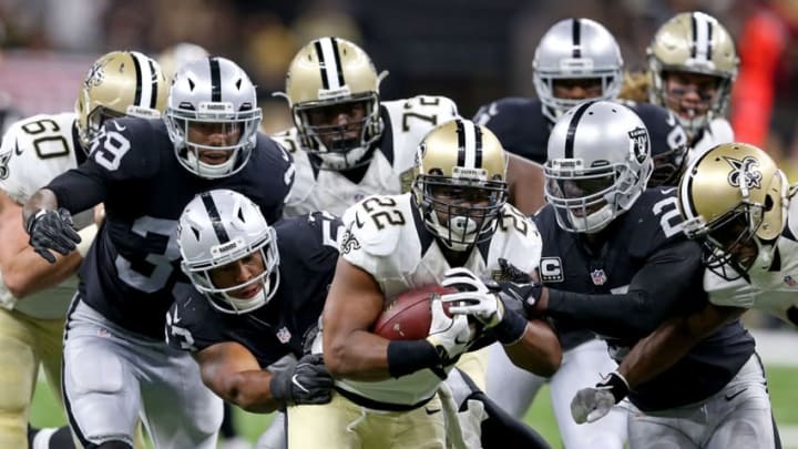 Sep 11, 2016; New Orleans, LA, USA; New Orleans Saints running back Mark Ingram (22) runs while being chased by a host of Oakland Raiders defenders in the fourth quarter at the Mercedes-Benz Superdome. The Raiders won 35-34. Mandatory Credit: Chuck Cook-USA TODAY Sports