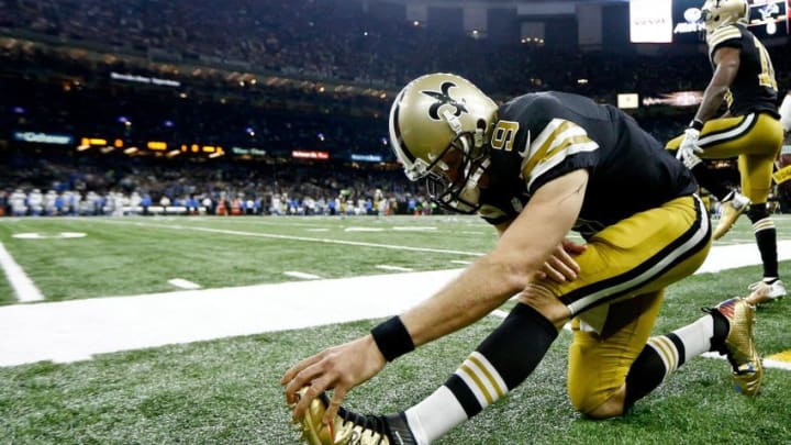 Dec 4, 2016; New Orleans, LA, USA; New Orleans Saints quarterback Drew Brees (9) wearing custom cleats supporting the Brees Dream Foundation stretches before a game against the Detroit Lions at the Mercedes-Benz Superdome. Mandatory Credit: Derick E. Hingle-USA TODAY Sports