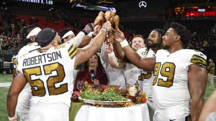 ATLANTA, GA - NOVEMBER 28: Members of the New Orleans Saints celebrate their victory with turkey legs following an NFL game against the Atlanta Falcons at Mercedes-Benz Stadium on November 28, 2019 in Atlanta, Georgia. (Photo by Todd Kirkland/Getty Images)