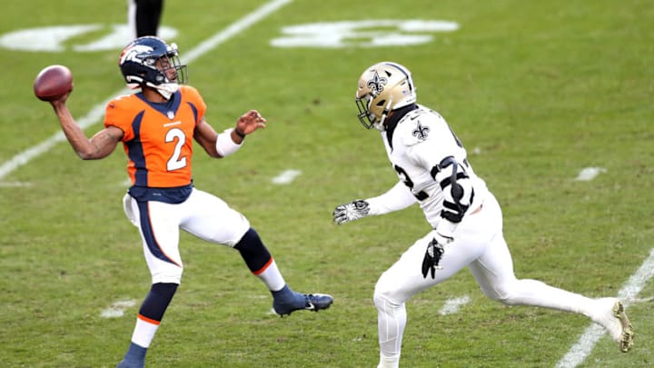 DENVER, COLORADO - NOVEMBER 29: Kendall Hinton #2 of the Denver Broncos passes under pressure from Marcus Davenport #92 of the New Orleans Saints during the third quarter of a game at Empower Field At Mile High on November 29, 2020 in Denver, Colorado. (Photo by Matthew Stockman/Getty Images)