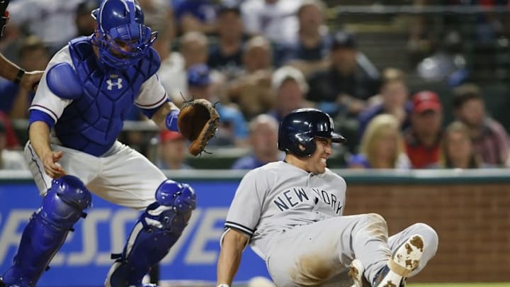 Apr 25, 2016; Arlington, TX, USA; New York Yankees center fielder Jacoby Ellsbury (22) reacts to being hit by a foul ball as Texas Rangers catcher Brett Nicholas (63) looks on in the ninth inning at Globe Life Park in Arlington. New York won 3-1. Mandatory Credit: Tim Heitman-USA TODAY Sports