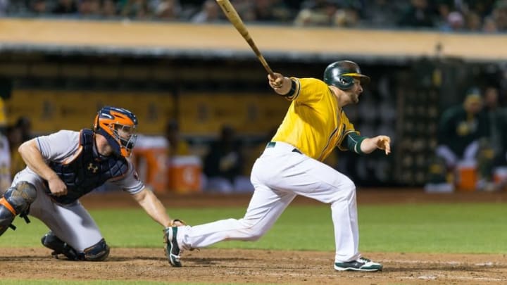 Sep 20, 2016; Oakland, CA, USA; Oakland Athletics catcher Stephen Vogt (21) grounds out scoring Oakland Athletics left fielder Jake Smolinski (not pictured) during the sixth inning in front of Houston Astros catcher Evan Gattis (11) at the Oakland Coliseum. Mandatory Credit: Neville E. Guard-USA TODAY Sports